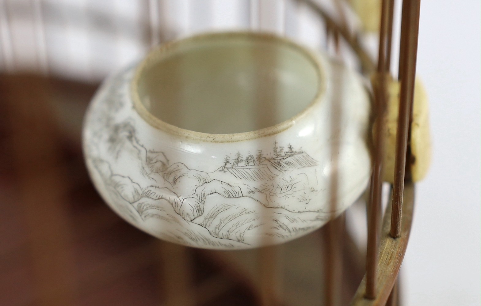 A Chinese bamboo and Guangzhou ivory mounted bird cage, late Qing dynasty, with two Guangxu mark and period porcelain bird feeders (1875-1908), cage 32.5cm high to top of handle
